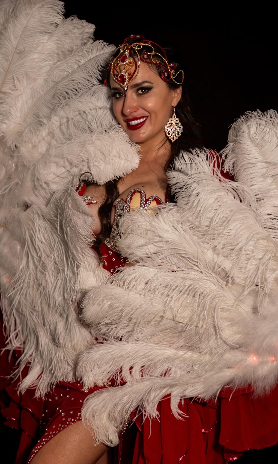Studio portrait of Amazing Ivanna in costume with ostrich feather fans