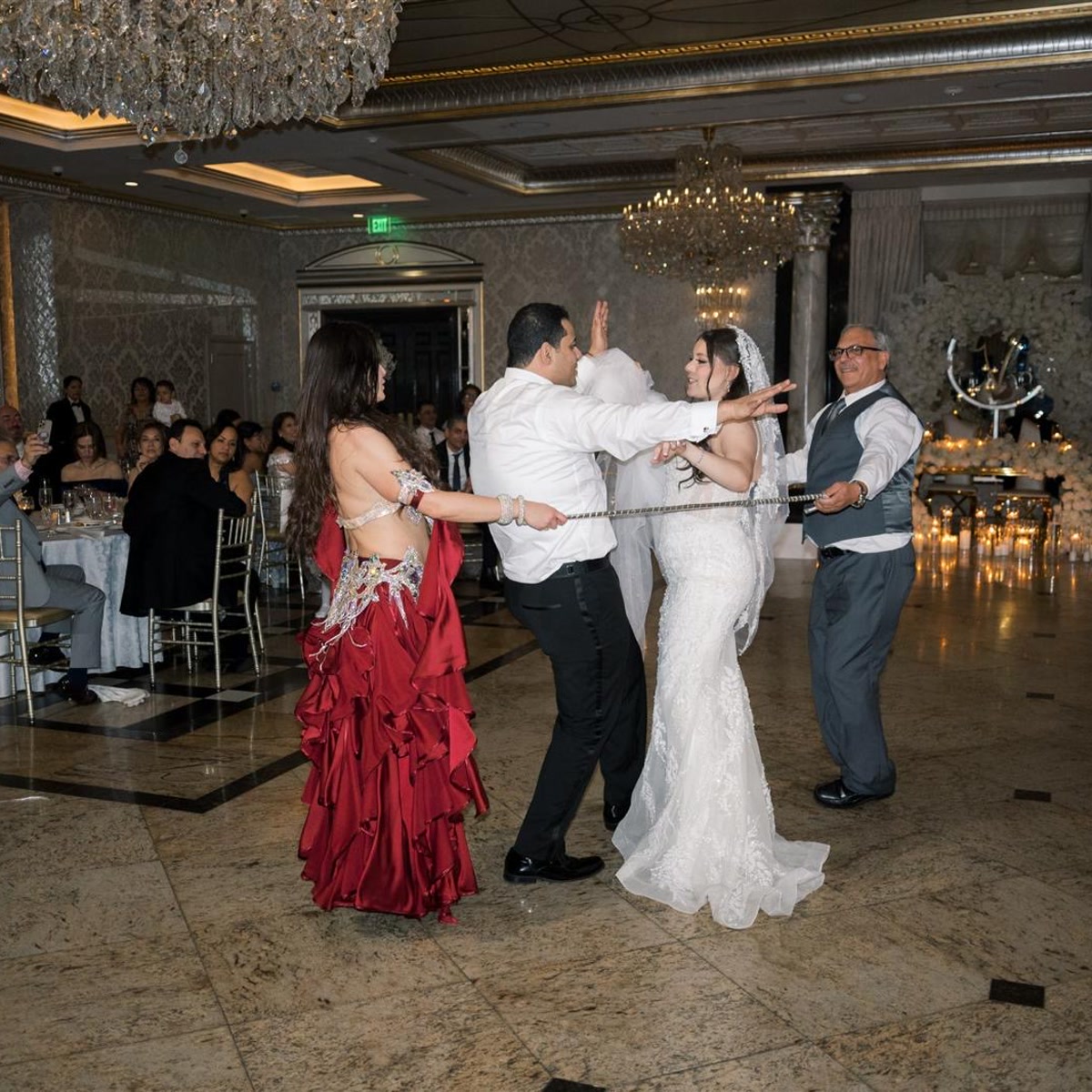 Bride and groom dancing with Ivanna during a cane feature